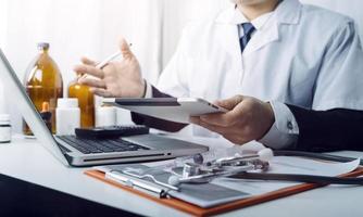 Medicine doctor and stethoscope touching icon medical network connection with modern interface on digital tablet in hospital background. Medical technology network concept photo