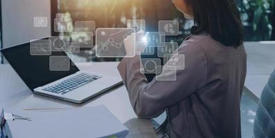 Big data analytics and business intelligence concept with chart and graph icons on a digital screen interface and a businessman hand in background photo