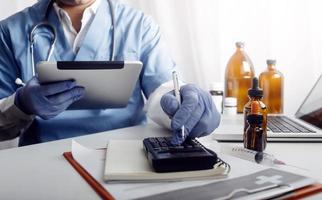 Medicine doctor and stethoscope touching icon medical network connection with modern interface on digital tablet in hospital background. Medical technology network concept photo