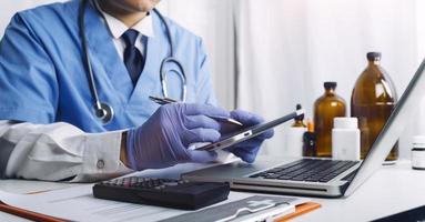 Medicine doctor and stethoscope touching icon medical network connection with modern interface on digital tablet in hospital background. Medical technology network concept photo