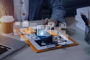 Big data analytics and business intelligence concept with chart and graph icons on a digital screen interface and a businessman hand in background photo