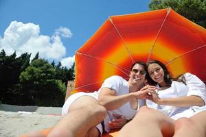 happy couple have fun on the beach photo