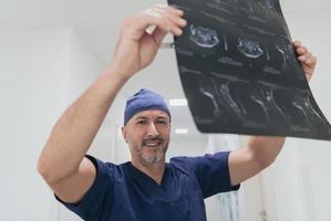 Orthopedist doctor examining X-ray picture in hospital or clinic photo