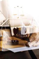 Justice and law concept.Male judge in a courtroom with the gavel, working with, computer and docking keyboard, eyeglasses, on table in morning light photo