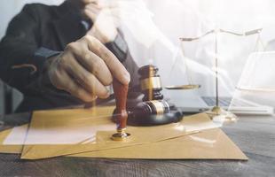 justice and law concept.Male judge in a courtroom on wooden table and Counselor or Male lawyer working in office. Legal law, advice and justice concept. photo