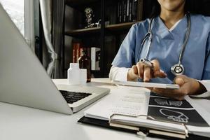 Medicine doctor and stethoscope touching icon medical network connection with modern interface on digital tablet in hospital background. Medical technology network concept photo