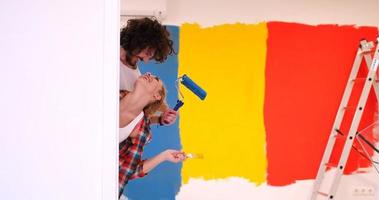 portrait of a couple painting interior wall photo