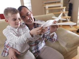 father and son assembling airplane toy photo