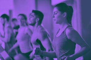 Group of people running on treadmills photo