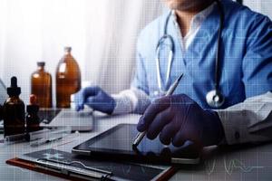 Medicine doctor and stethoscope touching icon medical network connection with modern interface on digital tablet in hospital background. Medical technology network concept photo