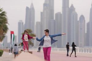 mother and cute little girl on the promenade photo