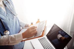 Medicine doctor and stethoscope touching icon medical network connection with modern interface on digital tablet in hospital background. Medical technology network concept photo