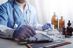Medicine doctor and stethoscope touching icon medical network connection with modern interface on digital tablet in hospital background. Medical technology network concept photo
