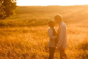 Couple running to the sunset photo