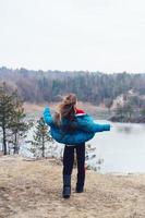 Young beautiful girl posing on a background of lake photo