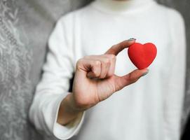 Girl holding a small lovely heart photo