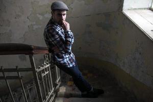 The man in the authentic boots and selvedge jeans  on a background of old city photo