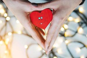 girl holding a red heart in the hands photo