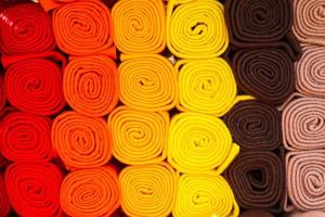 Detailed close up view on samples of cloth and fabrics in different colors found at a fabrics market photo