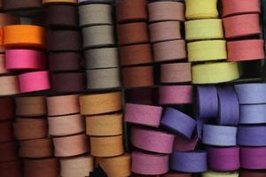 Detailed close up view on samples of cloth and fabrics in different colors found at a fabrics market photo