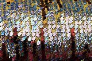 Detailed close up view on samples of cloth and fabrics in different colors found at a fabrics market photo