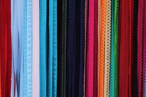 Detailed close up view on samples of cloth and fabrics in different colors found at a fabrics market photo