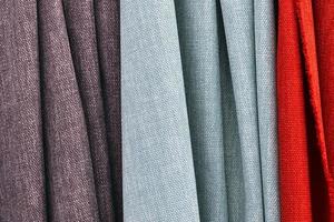 Detailed close up view on samples of cloth and fabrics in different colors found at a fabrics market photo