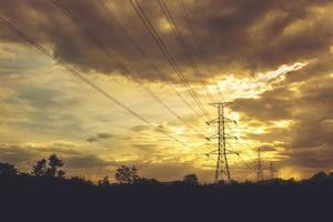 Electric power line with colorful sky at sunset - Vibrant color effect photo