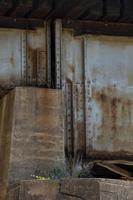 Concrete and metal underside of a bridge. photo