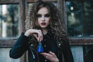 Vintage witch with elixir in hand photo