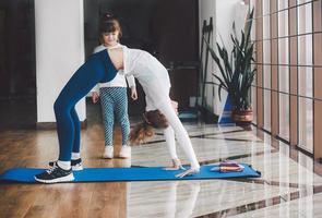 Two girls of different ages makeing yoga photo