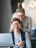 Girlfriend making her boyfriend surprise and closing eyes photo