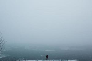 beautiful young couple standing on a pier photo