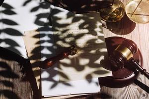 Business and lawyers discussing contract papers with brass scale on desk in office. Law, legal services, advice, justice and law concept picture with film grain effect photo