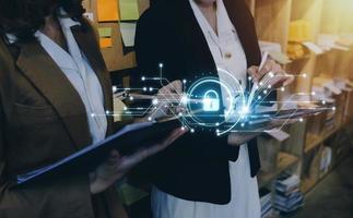 Cybersecurity and privacy concepts to protect data. Lock icon and internet network security technology. Businessman protecting personal data on smart phone with virtual screen interfaces. photo