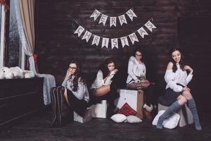 Four charming model posing on a vintage New Year's background photo