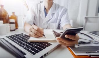 Medicine doctor and stethoscope touching icon medical network connection with modern interface on digital tablet in hospital background. Medical technology network concept photo