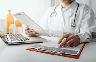 Medicine doctor and stethoscope touching icon medical network connection with modern interface on digital tablet in hospital background. Medical technology network concept photo