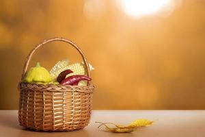 Autumn still life with basket and vegetables, autumn fall leaf on background with sunlight. Abstract autumn composition with copy space photo