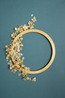 Golden ring and dried hydrangea flowers on a green background. Flat lay, top view, copy space photo