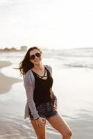 Young beautiful girl posing by the sea photo