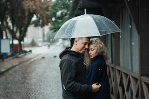Couple on the street with umbrella photo