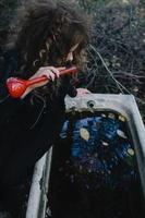 Vintage witch with elixir in hand photo