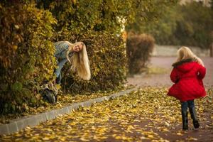 Mother with daughter in autumn park photo