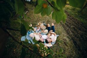 Happy family on lawn in the park photo