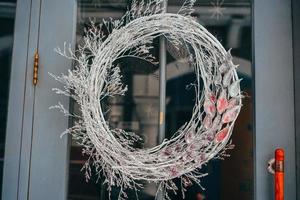 Christmas wreath hanging on the glass door in cafe