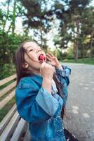 Girl sitting on bench with candies photo