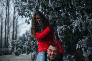 man carries his girlfriend on back photo