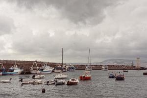 Berth with boats on sea shore photo