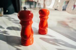 salt and pepper grinders on a table photo